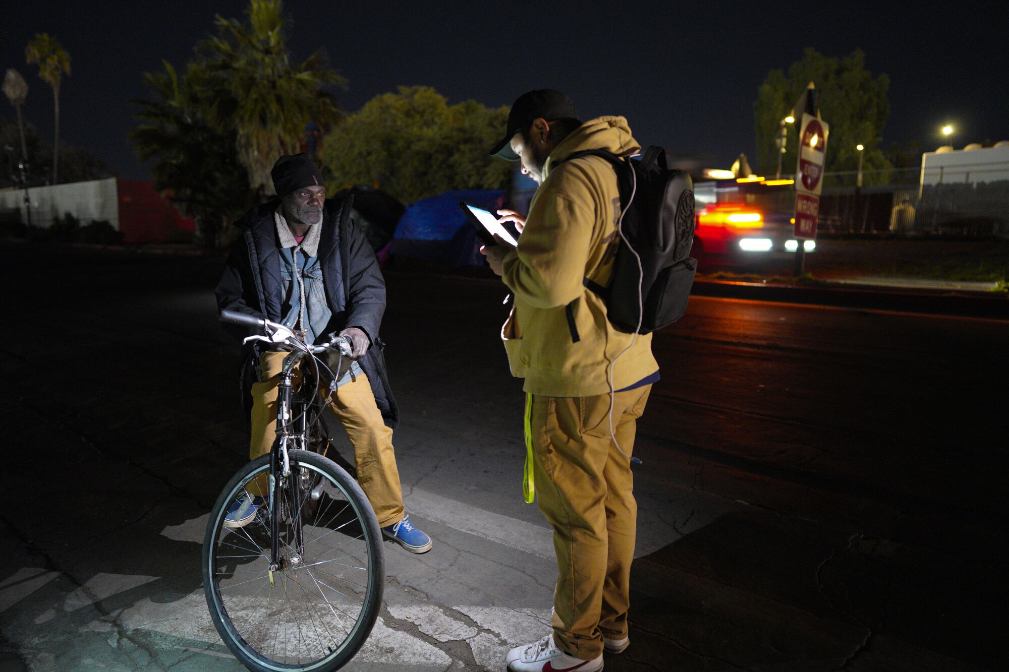 Homeless man Michael Pollard is interviewed by outreach worker Miguel Figueroa. 
