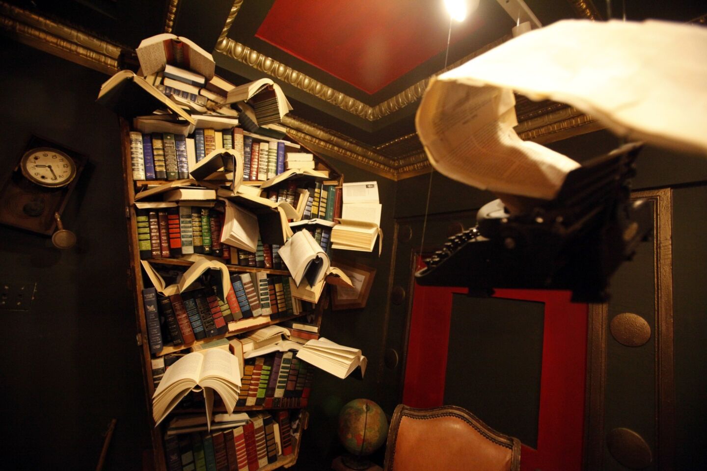 A bookcase featuring flying books created by artist David Lovejoy and titled "Diagnosis" is in the Labyrinth. The floating typewriter and paper flowing from it were created by artist Jena Priebe.