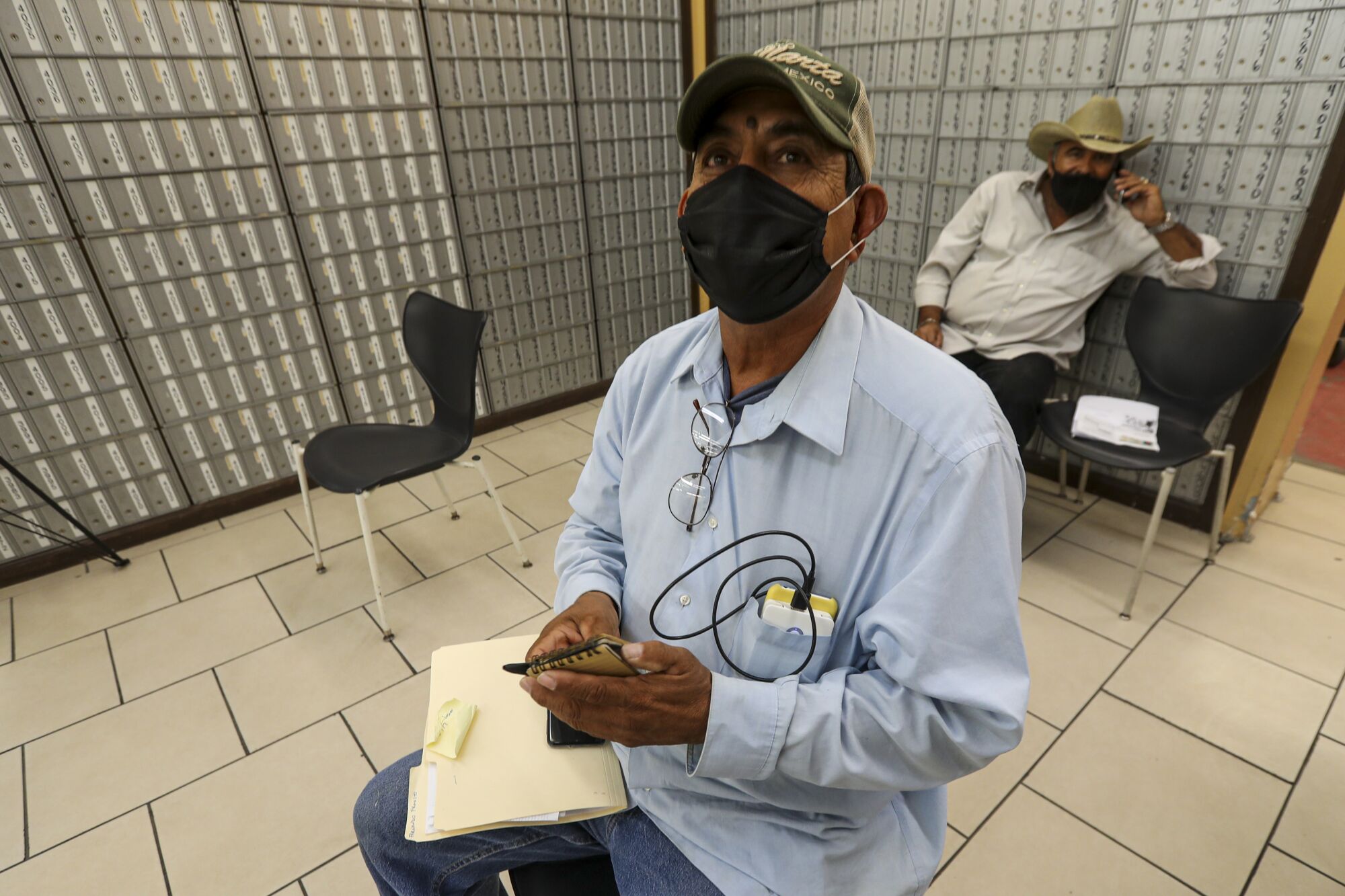 Fernando Fausto, 59, a resident of Mexicali, waits at a private service agency to file for unemployment in Calexico.