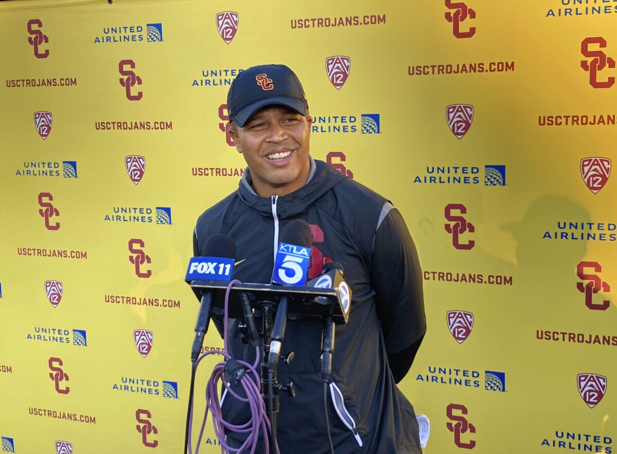 USC interim head football coach Donte Williams smiles while answering questions after practice.
