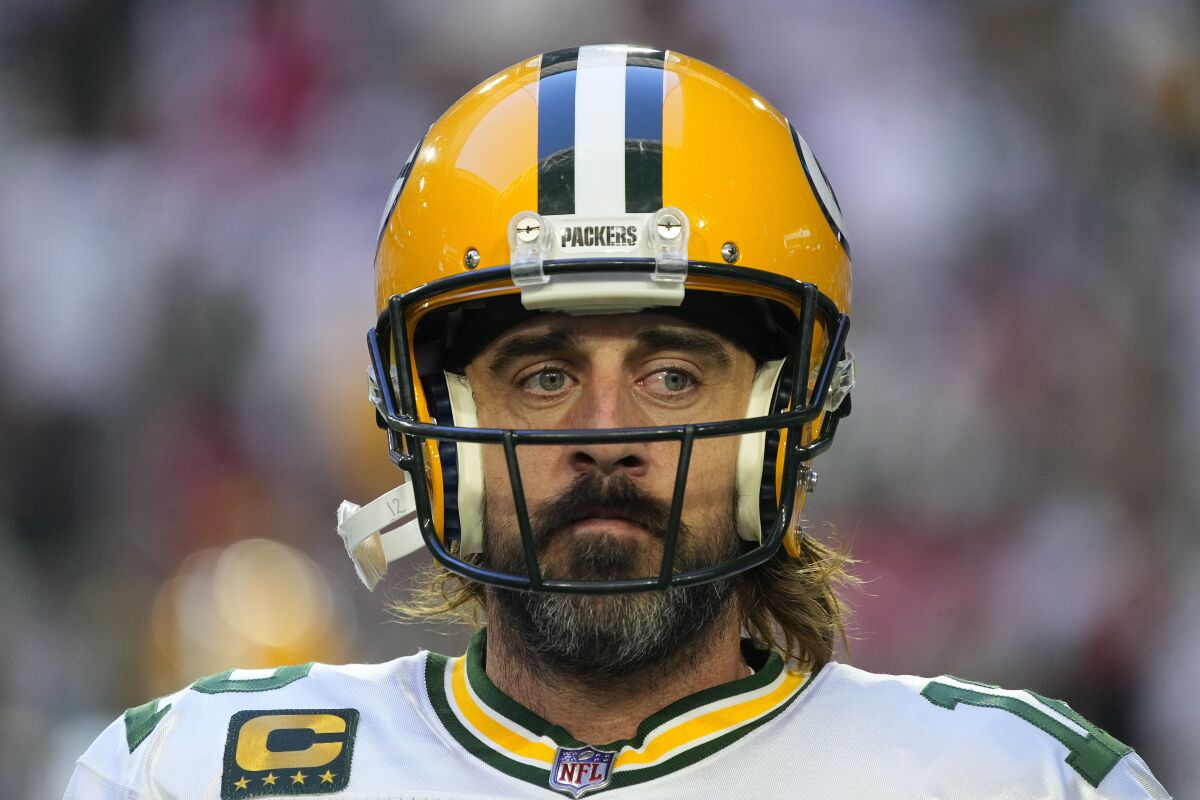 Aaron Rodgers wears a football helmet before a game.