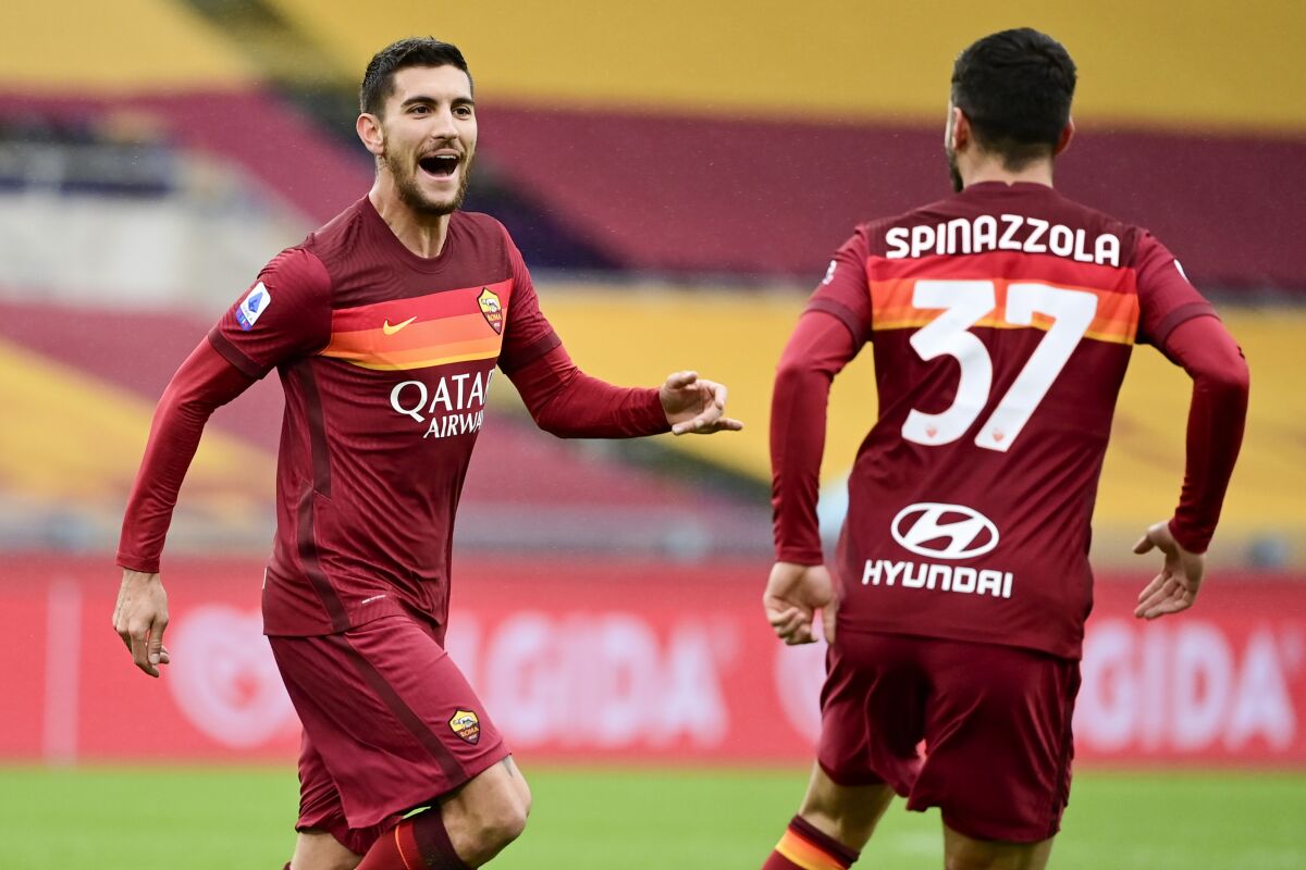 Roma's Lorenzo Pellegrini, left, celebrates with his teammate Leonardo Spinazzola after scoring his side's first goal during a Serie A soccer match between Roma and Inter Milan, at Rome's Olympic Stadium, Sunday, Jan. 10, 2021. (Luciano Rossi/LaPresse via AP)