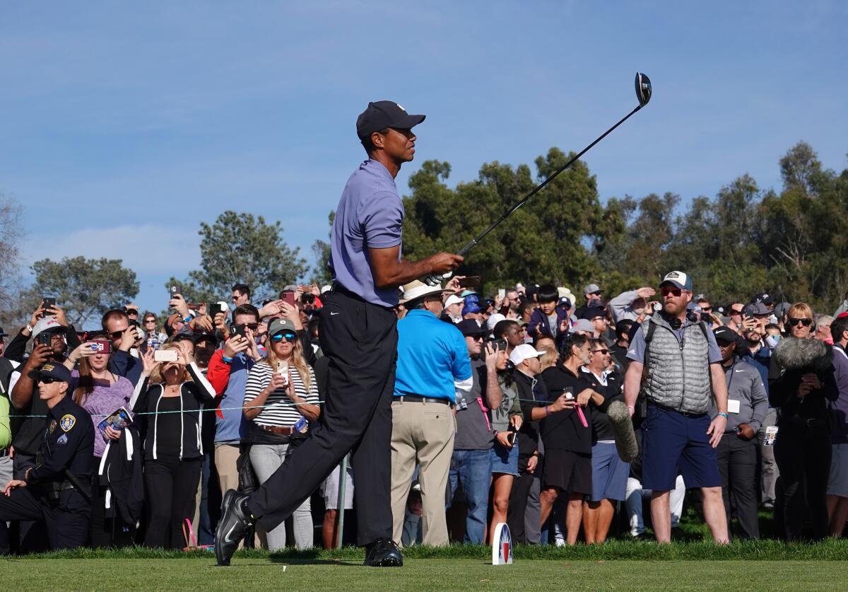 Tiger Woods tees off on his 18th hole on the Torrey Pines North Course during the first round of the Farmers Insurance Open.