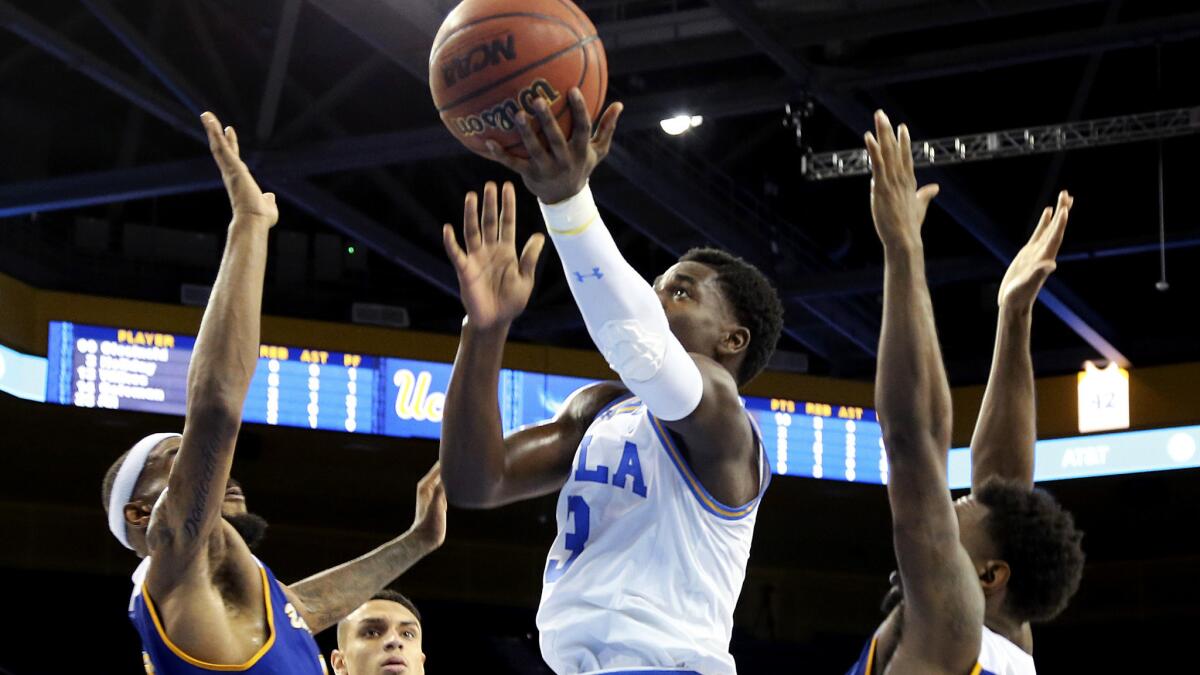 UCLA guard Aaron Holiday shoots over Cal State Bakersfield defenders during the second half of a game on Nov. 29. UCLA won 75-66.