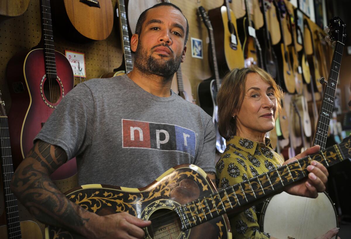 Musician Ben Harper and his mom, Ellen Harper, inside their family-owned music store Folk Music Center in Claremont.