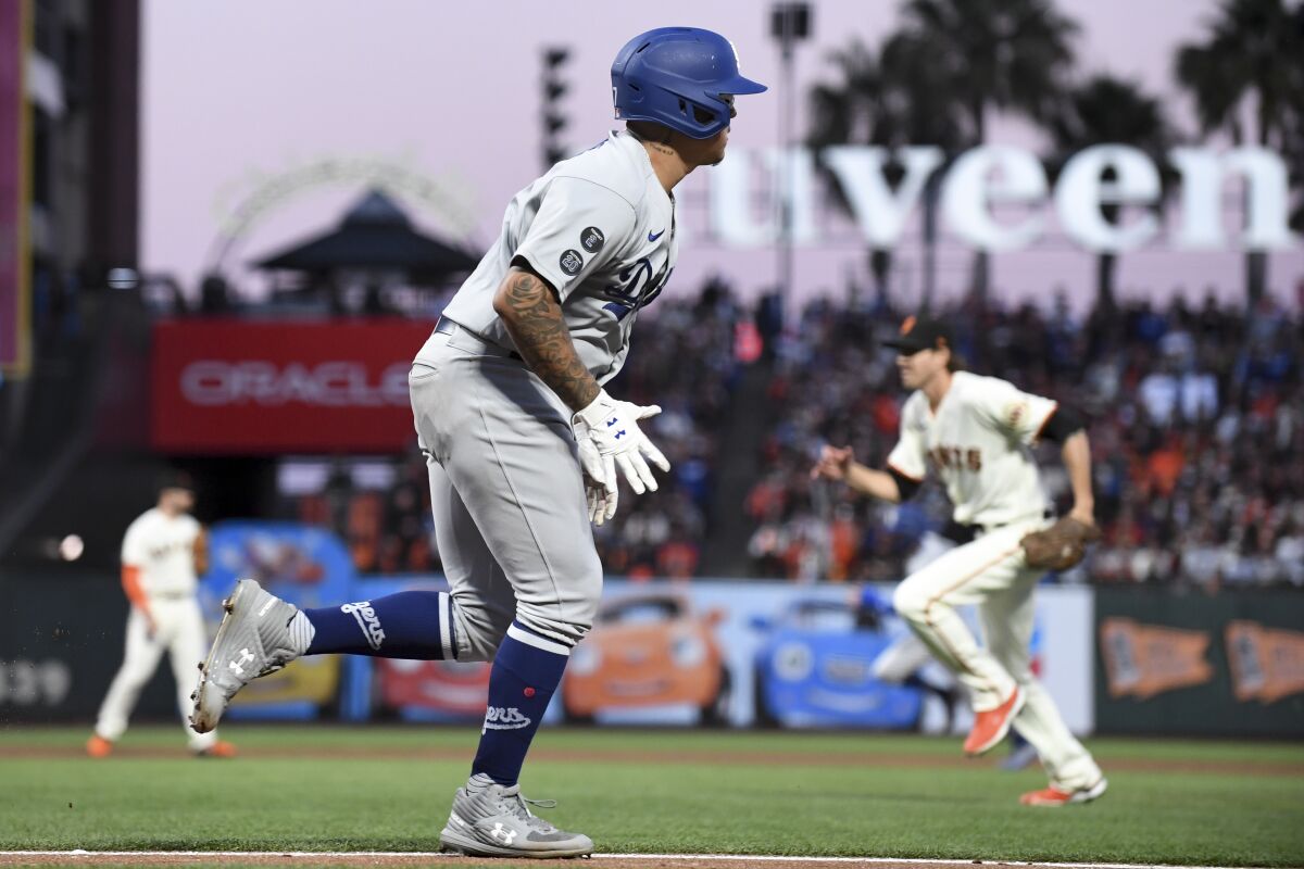 The Dodgers' Julio Urías runs to first base after hitting an RBI single during the second inning.