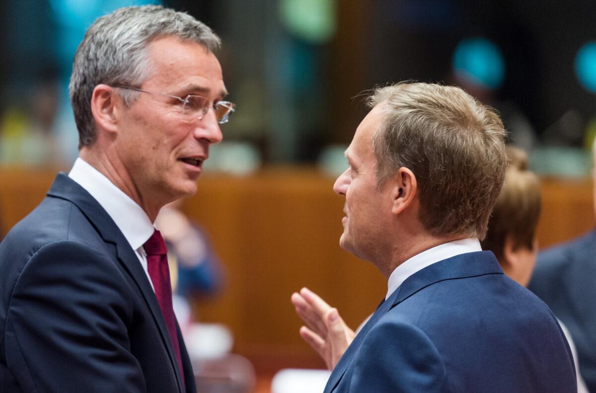European Council President Donald Tusk, right, speaks with NATO Secretary-General Jens Stoltenberg during a meeting between the Western military alliance and officials of the European Union, which is also enduring strained relations with Russia.