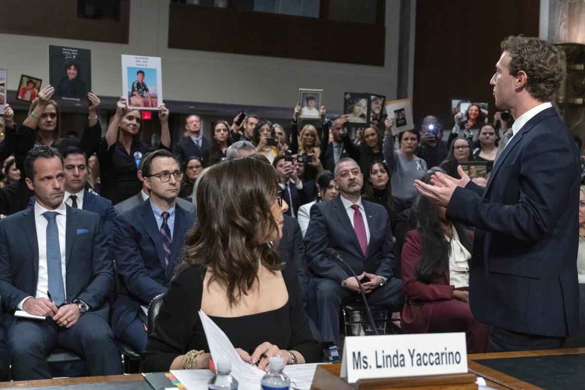 Mark Zuckerberg addresses the audience during a Senate hearing. Linda Yaccarino, seated, watches at left.