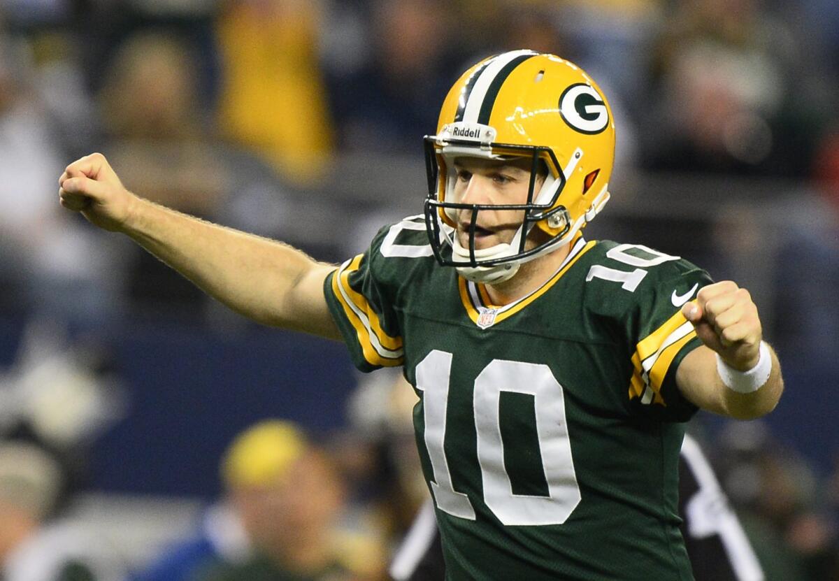 Matt Flynn, then quarterback for the Green Bay Packers, celebrates a touchdown against the Dallas Cowboys in December 2013. On Friday, Flynn signed with the New England Patriots.