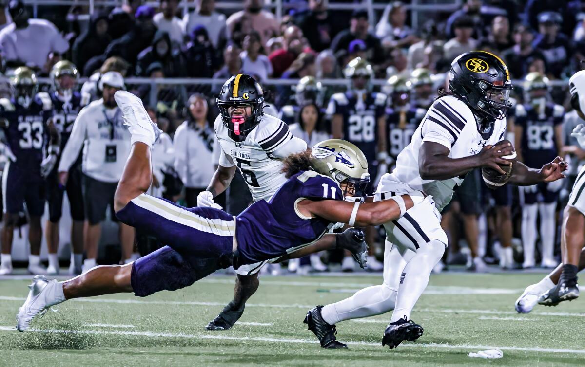 The second Matthew Muasua of St. John Bosco does everything to shoot Jae'oyn Williams of St. Frances.