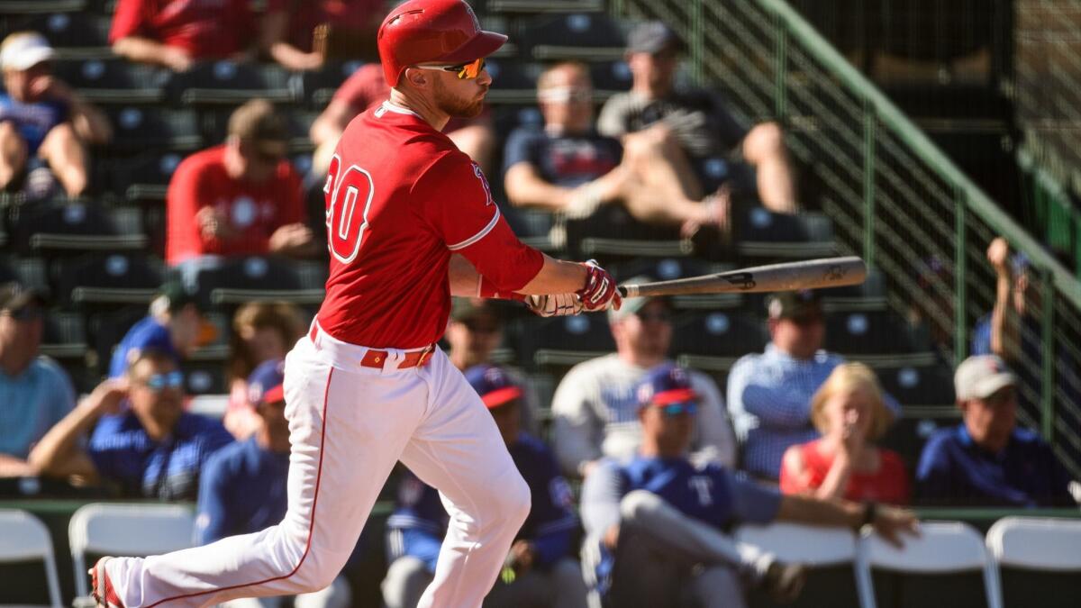 The Angels' Jonathan Lucroy singles against the Texas Rangers during a spring training game at Tempe (Ariz.) Diablo Stadium on Thursday.