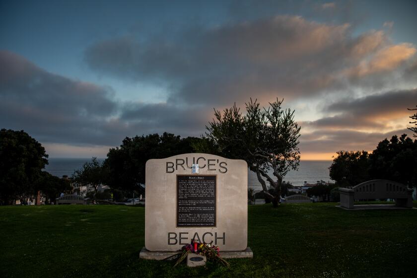 Manhattan Beach, CA - June 28: The sign and memorial for Bruce's Beach in Manhattan Beach, CA, the evening the Los Angeles County Board of Supervisors unanimously approved the plan to return the beach land to the family it was taken from nearly a century ago, photographed Tuesday, June 28, 2022. (Jay L. Clendenin / Los Angeles Times)