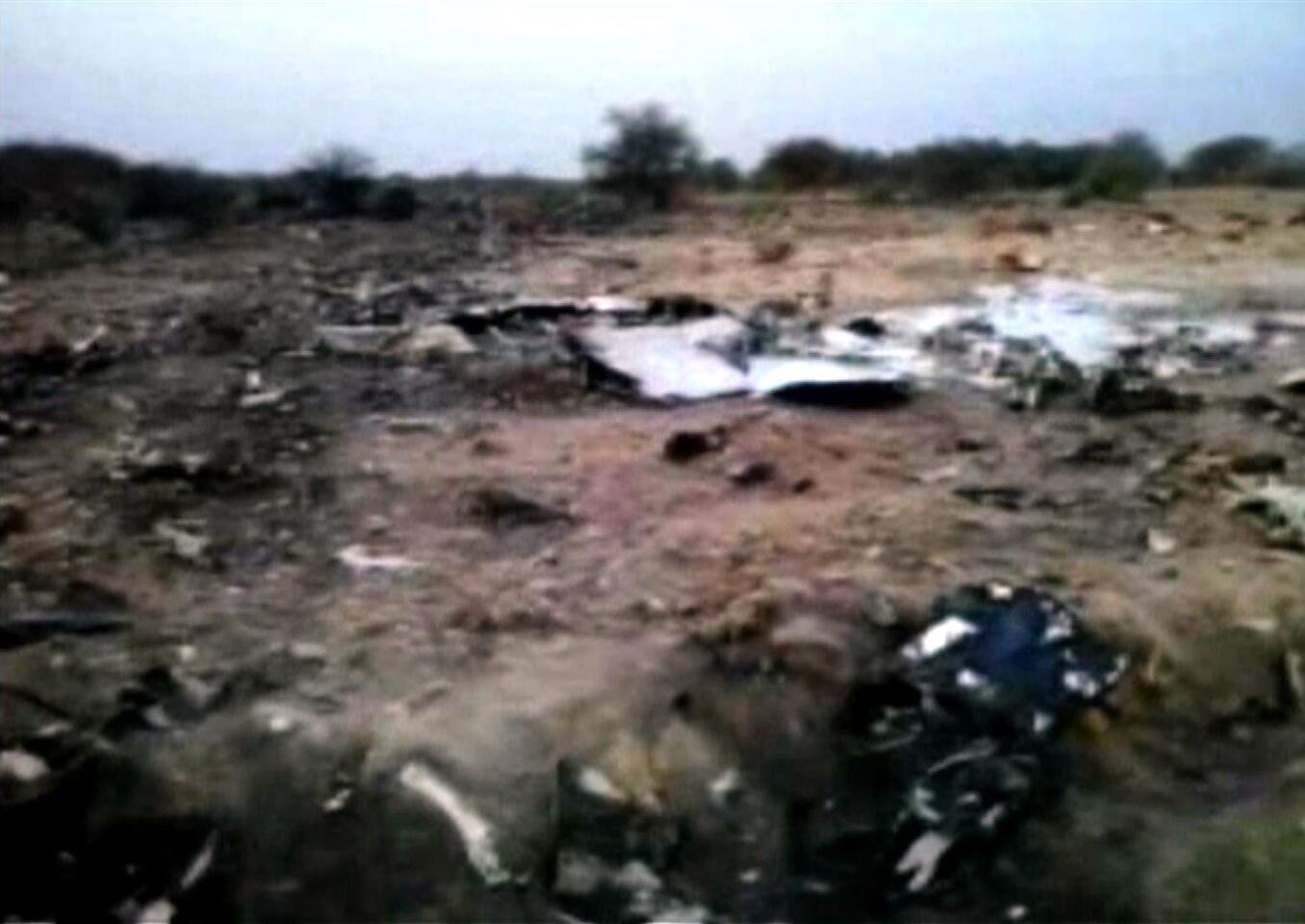 Debris is seen at the crash site of Air Algerie flight AH5017 near the northern Mali town of Gossi.