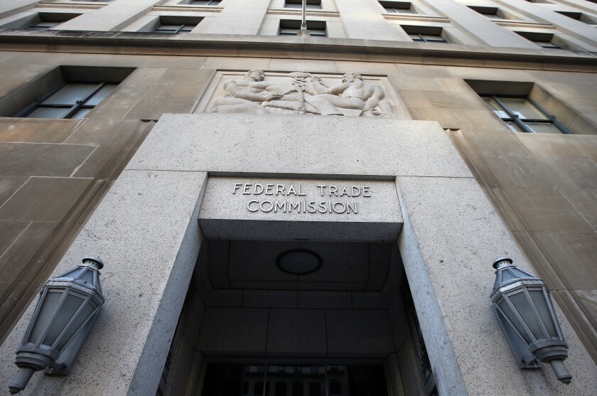 FILE - This Jan. 28, 2015, file photo shows the Federal Trade Commission building in Washington. Walmart and Kohl's are paying a combined $5.5 million in settlements after the Federal Trade Commission said they falsely marketed dozens of sheets and other home textile products as made of environmentally friendly bamboo, when they were actually rayon. (AP Photo/Alex Brandon, File)