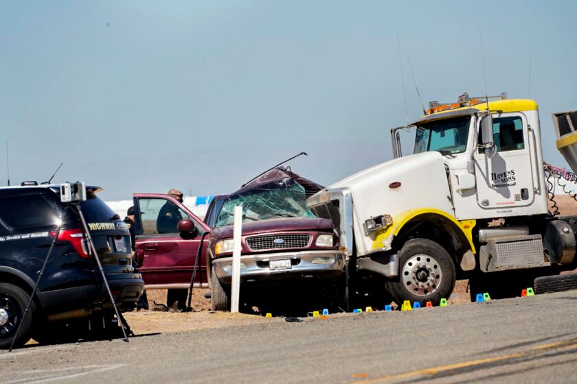 HOLTVILLE, CA - MARCH 02: Law enforcement inspect the scene of a deadly crash at State Route 115 on Tuesday, March 2, 2021 in Holtville, CA. The crash, which took place near the U.S.-Mexico border Tuesday morning, left 15 people dead and several others injured, officials said.(Nelvin C. Cepeda / The San Diego Union-Tribune)