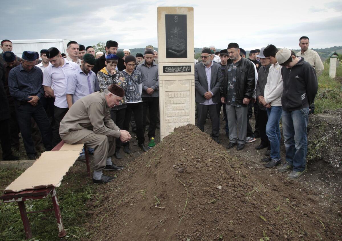Abdul-Baki Todashev, fourth right, mourns during the funeral of his son, Ibragim Todashev, outside Grozny, Chechnya's provincial capital, on June 20, 2013. Ibragim Todashev, was killed by an FBI agent while being questioned about ties to the Boston Marathon bombing.