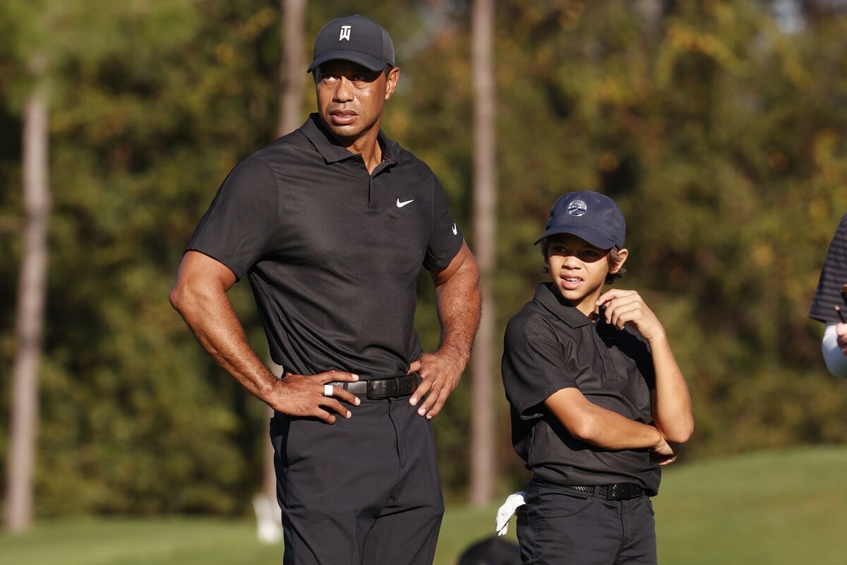 Tiger Woods and his son Charlie, 12, watch play during the pro-am round of the PNC Championship on Dec. 17, 2021.
