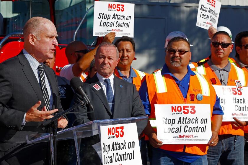 California Gov. Jerry Brown and others express their opposition to Proposition 53 at the United Firefighters headquarters in Los Angeles on Nov. 3.