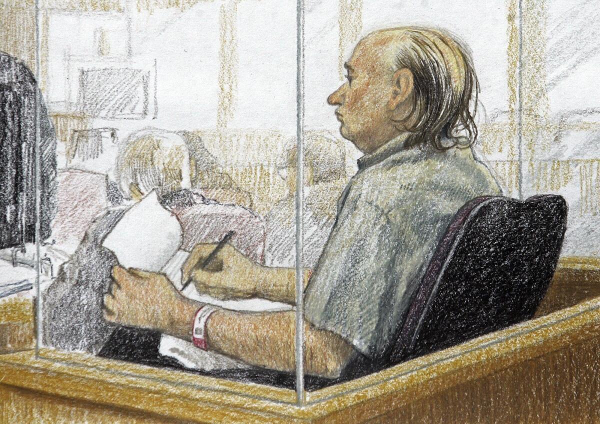 This artist's sketch shows serial killer Robert Pickton taking notes behind a clear partition in a courtroom.