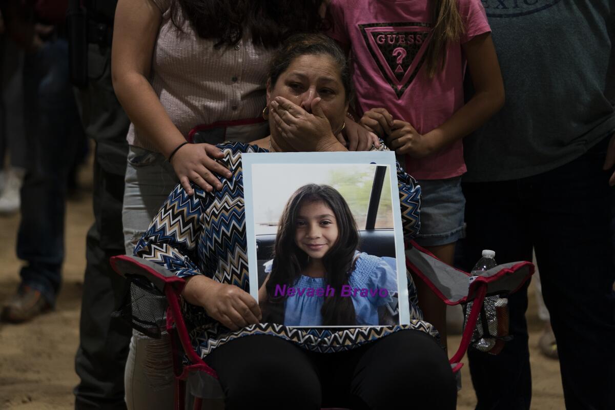 Esmeralda Bravo, 63, cries while holding a photo of her granddaughter, Nevaeh, during a prayer vigil in Uvalde, Texas.