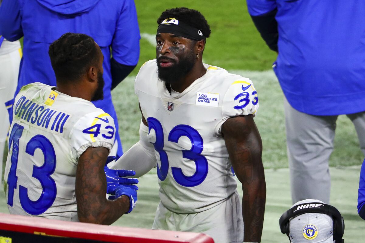 Rams' Nick Scott (33) talks with teammate John Johnson on the sideline during a win over Tampa Bay on Nov. 23.