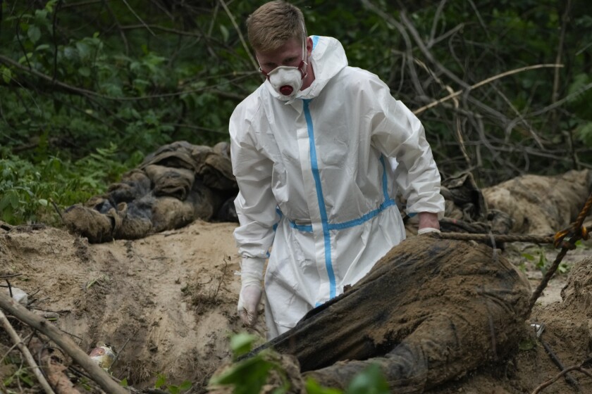 Exhumation worker at a mass grave near Kyiv