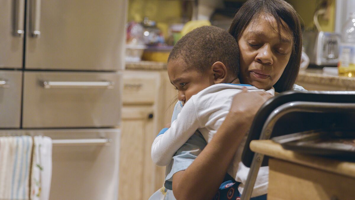 Nunu comforts Noah in the documentary "Through the Night."
