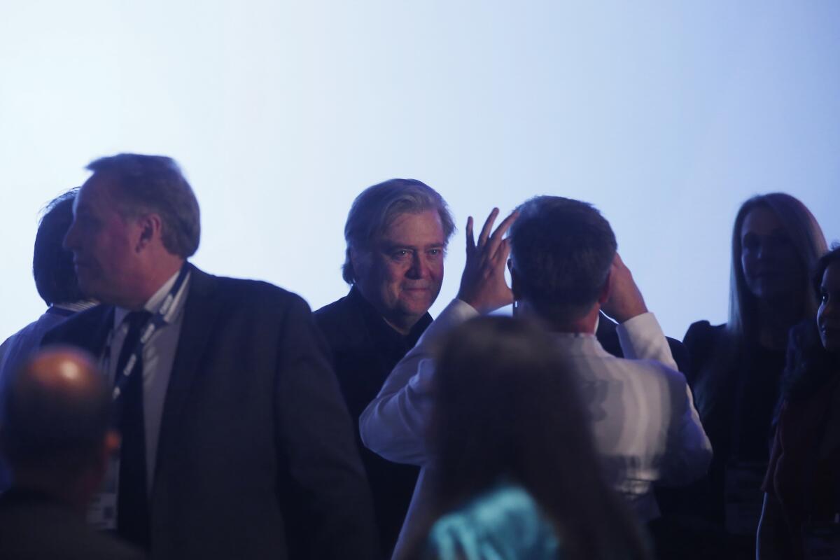 People gather around Stephen K. Bannon before he speaks at the California Republican Party convention at the Anaheim Marriott on Oct. 20.