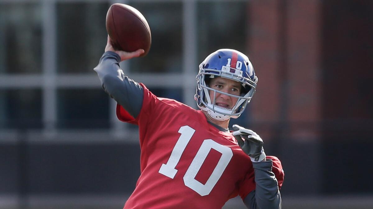 New York Giants quarterback Eli Manning throws during practice on Dec. 6.