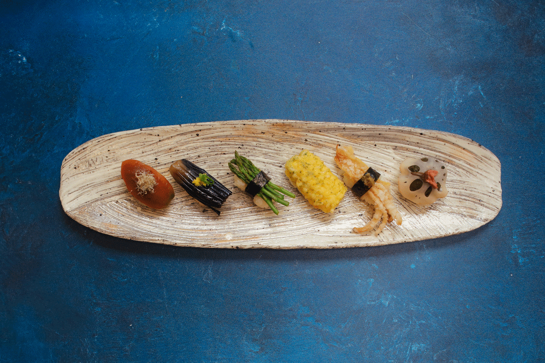 A platter holds a selection of vegan sushi.