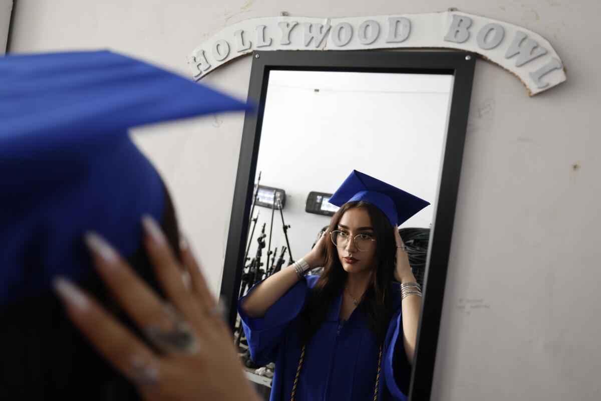 Alanah Chamberlain fixes her cap in the mirror before walking on stage.