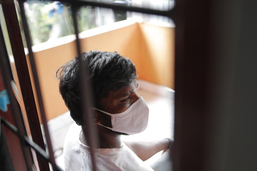 Sri Lankan auto rickshaw driver Prasad Dinesh, linked by Sri Lankan officials to nearly half the country's more than 2,600 coronavirus cases, sits in his house in Ja-Ela, Sri Lanka, Wednesday, July 1, 2020. For months he’s been anonymous, but now Dinesh is trying to clear his name and shed some of the stigma of a heroin addiction at the root of his ordeal. Referring to him only as “Patient 206,” government officials lambasted Dinesh on TV and social media, blaming him for at least three clusters of cases, including about 900 navy sailors who were infected after an operation in Ja-Ela, a small town about 19 kilometers (12 miles) north of the capital, Colombo. Dinesh, however, says his drug addiction, which is considered a crime in Sri Lanka, makes him a convenient scapegoat. (AP Photo/Eranga Jayawardena)