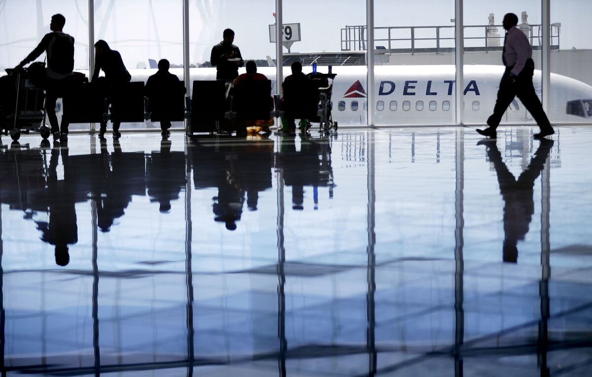 A Delta Air Lines jet sits at a gate at Hartsfield-Jackson Atlanta International Airport.