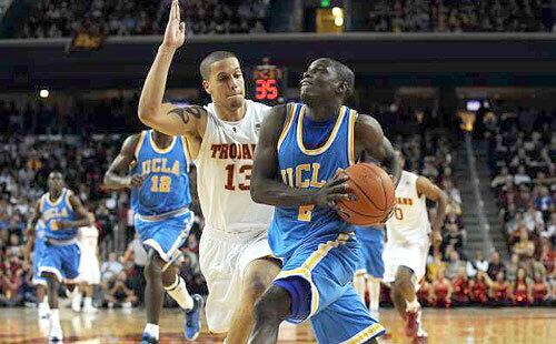 UCLA point guard Darren Collison has the inside track to the basket on a fast break against USC's Daniel Hackett during the second half Sunday.