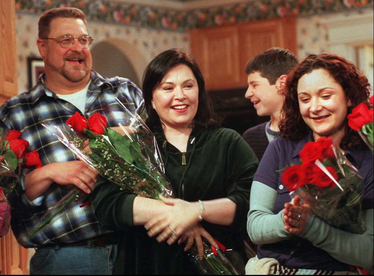 Roseanne, center, star of the longtime ABC sitcom "Roseanne," with co-stars John Goodman, left, Michael Fishman and Sara Gilbert after taping the last episode of the series in 1997.