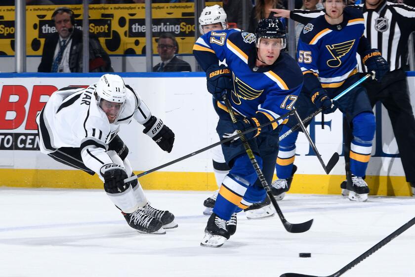 ST. LOUIS, MO - OCTOBER 17: Jaden Schwartz #17 of the St. Louis Blues passes the puck as Anze Kopitar #11 of the Los Angeles Kings defends at Enterprise Center on October 17, 2019 in St. Louis, Missouri. (Photo by Scott Rovak/NHLI via Getty Images)