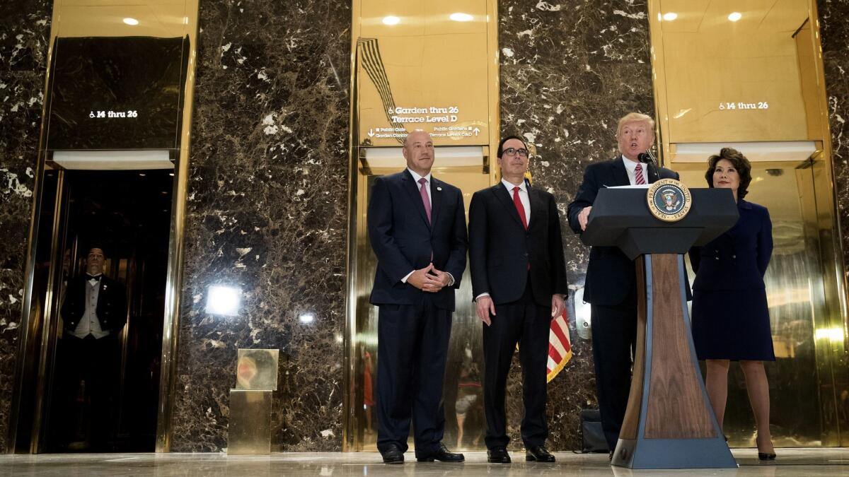 President Trump at Trump Tower on Tuesday, with National Economic Council Director Gary Cohn, left, Treasury Secretary Steven T. Mnuchin and Transportation Secretary Elaine Chao.