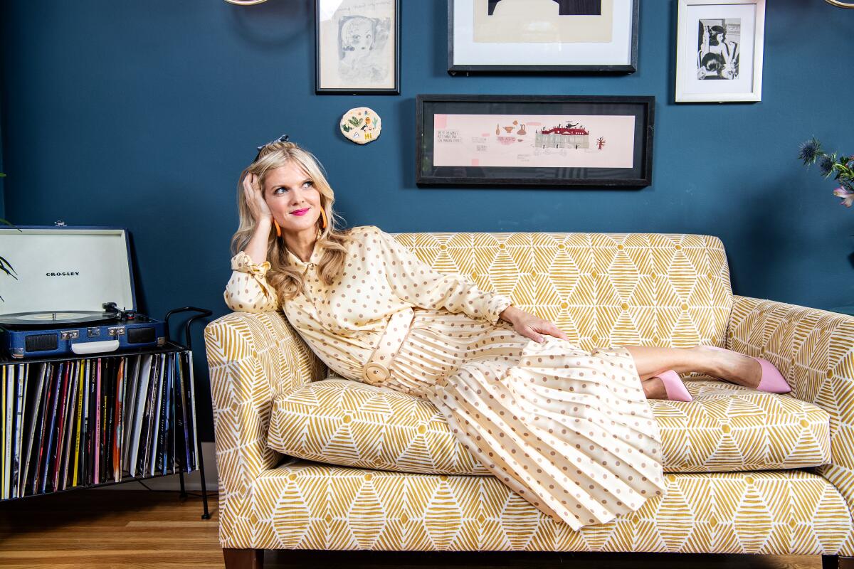Arden Myrin reclines on a sofa in her home in Silver Lake.