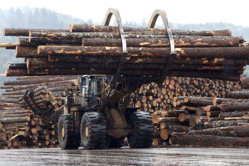 FILE - In this Feb. 26, 2015 photo, a front end log loader transports logs at Swanson Group Manufacturing in Roseburg, Ore. In Oregon, mass timber is increasingly being viewed as a construction material that could help the state build more affordable homes and revive rural logging towns. A new prototype of a mass timber affordable housing unit was unveiled at the Port of Portland on Friday, Jan. 27, 2023. (Michael Sullivan/The News-Review via AP, File)