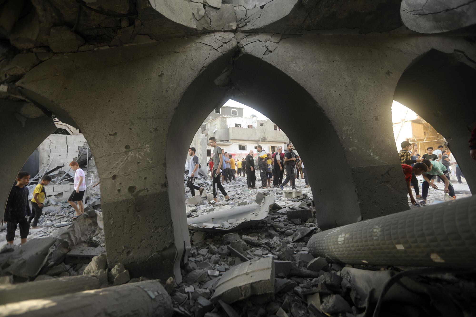 People inspecting the damage to a mosque from an Israeli strike in Gaza