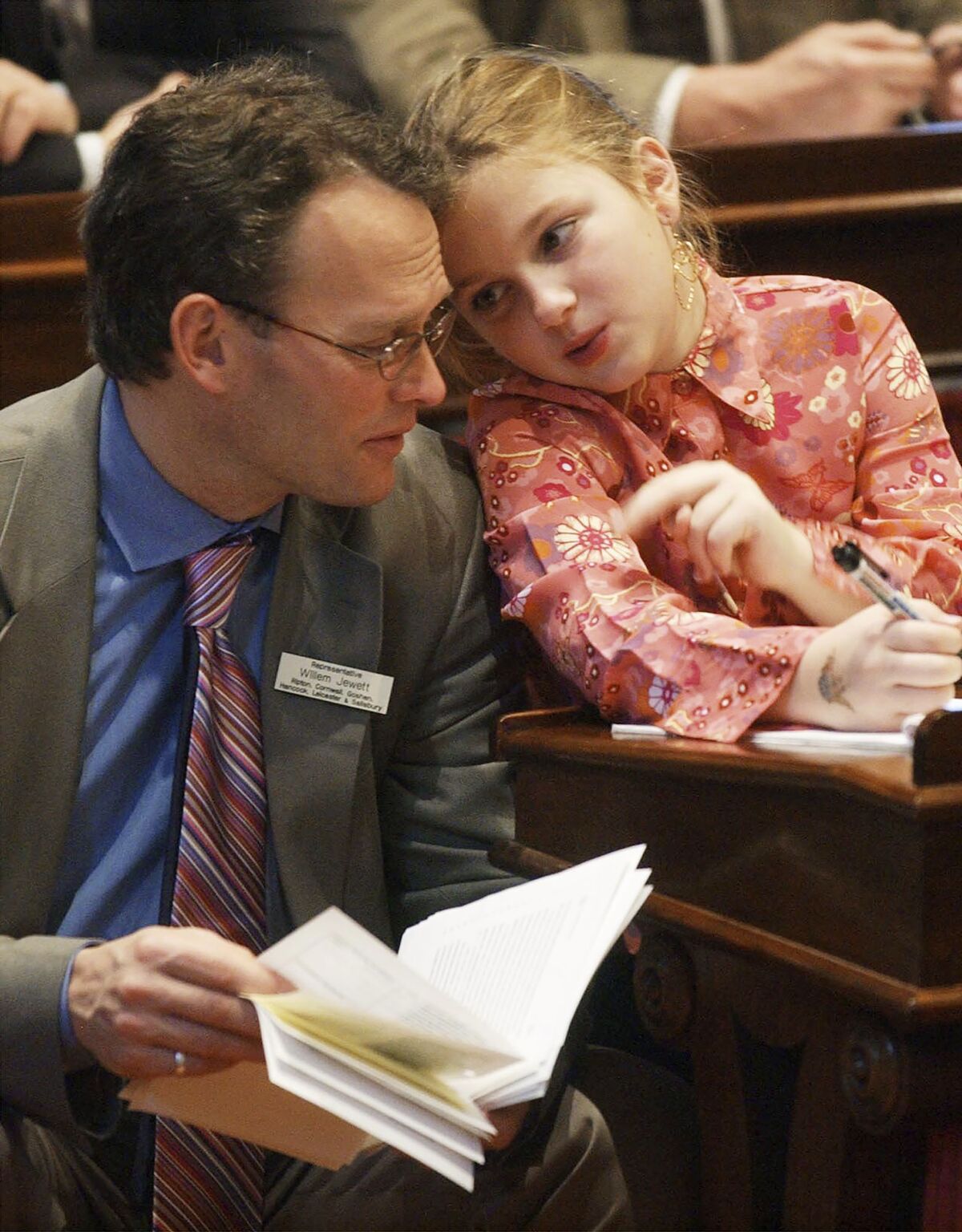 FILE — Vermont Rep. Willem Jewett, D-Ripton, left, chats with his daughter, Anneke, during the first day of the legislature, in Montpelier, Vt., Jan. 5, 2004. The former Vermont lawmaker and House majority leader died on Wednesday, Jan. 12, 2022. Jewett, who had cancer, helped pass a Vermont's aid-in-dying law that allows terminally ill patients to ask their doctors for a lethal dose of medication. (AP Photo/Toby Talbot, File)