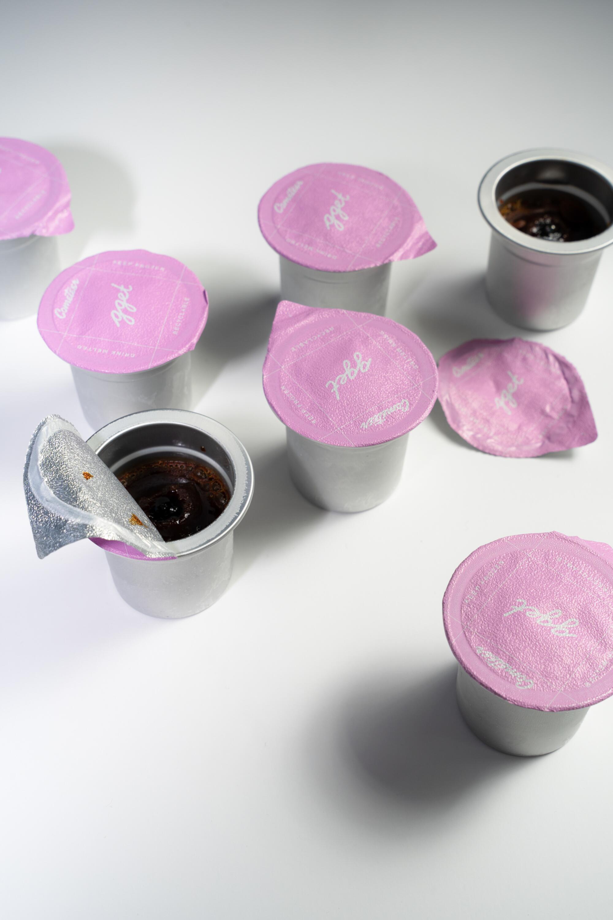 White plastic coffee pods with a pinkish top