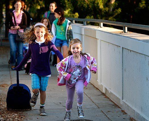 Parents and children on their way to Carpenter Avenue Elementary School in Studio City, many of whom are participating in International Walk to School Day on Wednesday. It was held to raise awareness and promote healthy kids and cleaner air.