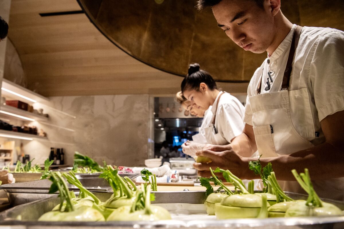 A small army of chefs prep for the evening's service at Somni.
