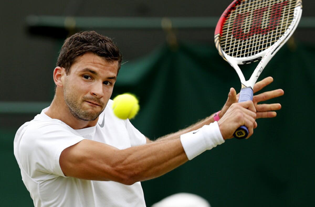 Grigor Dimitrov gets set to hit a backhand against Grega Zemlja during their second-round match at Wimbledon on Friday. Zemlja's 3-6, 7-6, 3-6, 6-4, 11-9 victory ended only the 12th five-set match in the first two men's singles rounds, the fewest at Wimbledon in the Open era.