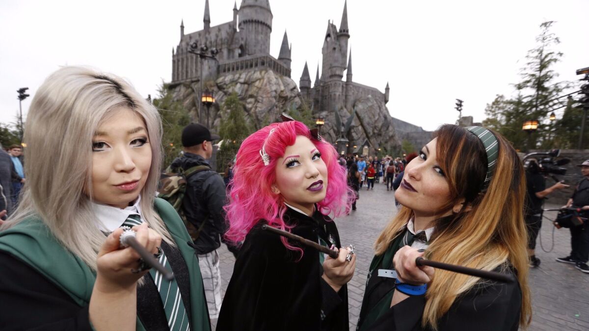 Diana Li, from left, Bebe Lee and Katie Mitchell enter the Wizarding World of Harry Potter at Universal Studios Hollywood on April 7, 2016.