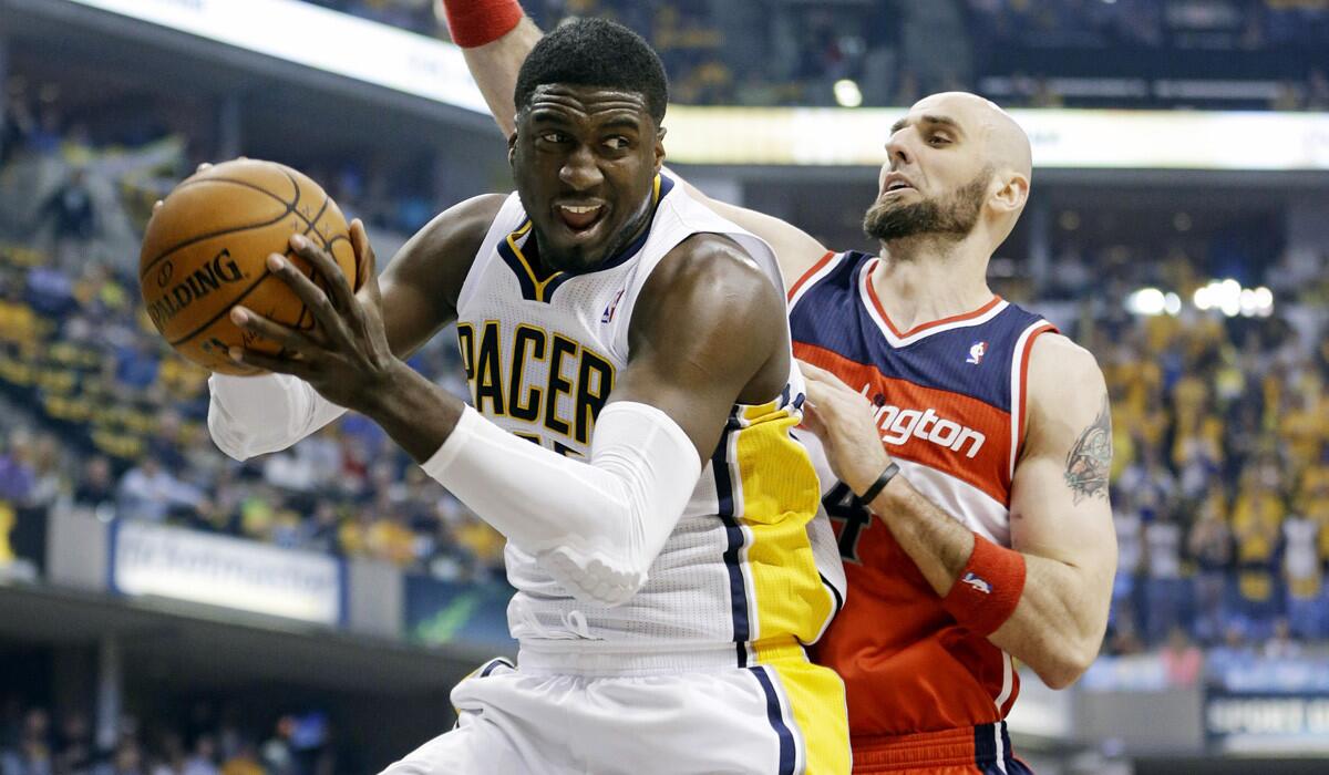 Pacers center Roy Hibbert grabs a rebound in front of Wizards center Marcin Gortat during the first half of Game 2 on Wednesday night.