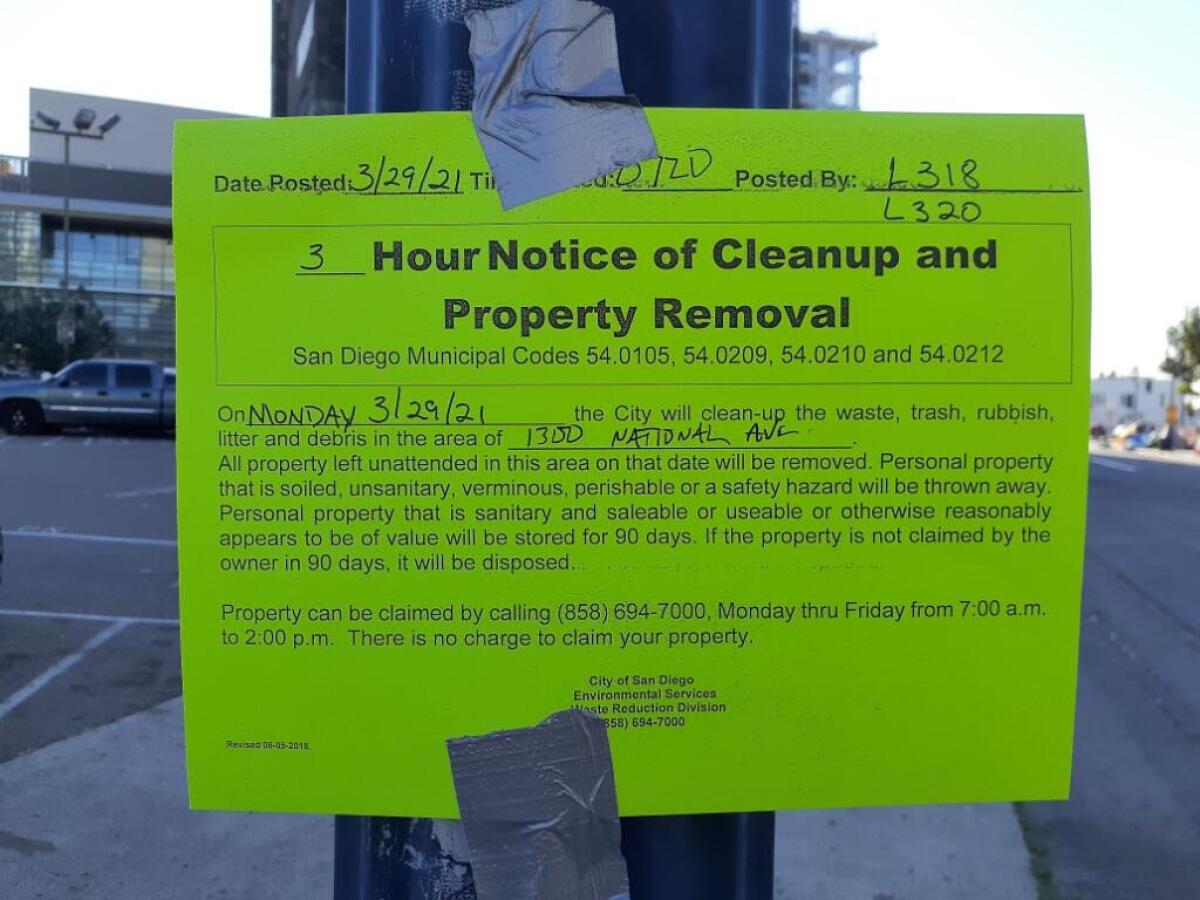 A paper sign gives a three-hour notice of a sidewalk cleanup.