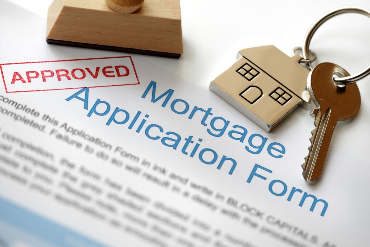 A mortgage application form with an "approved" stamp.