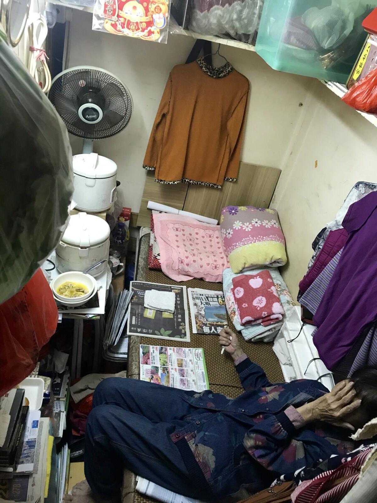 Han Li, 75, is one of more than a quarter of a million Hong Kong residents who live in subdivided flats.